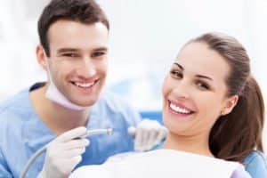 Male dentist and woman patient