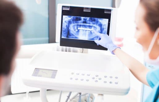 Dentist explaining digital x ray picture to patient