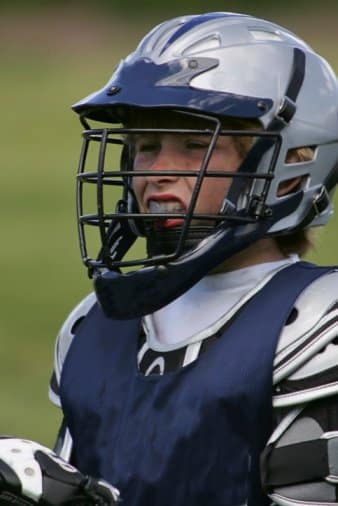 child with mouthguard playing football
