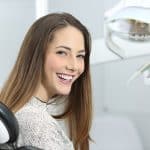 a girl smiling in a dentist chair